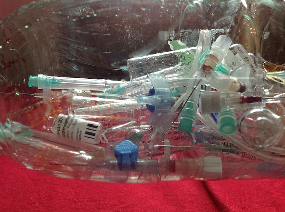 A close up of discarded syringes and medical waste