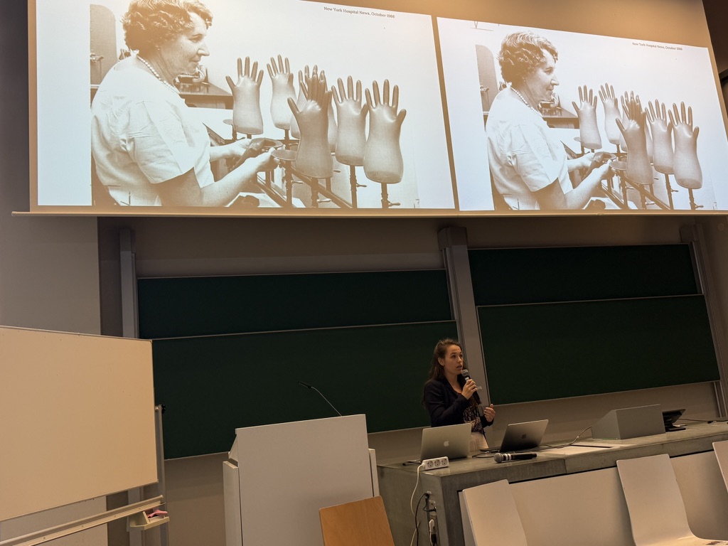 Eloise presenting with images from historical archives on the screen behind her.