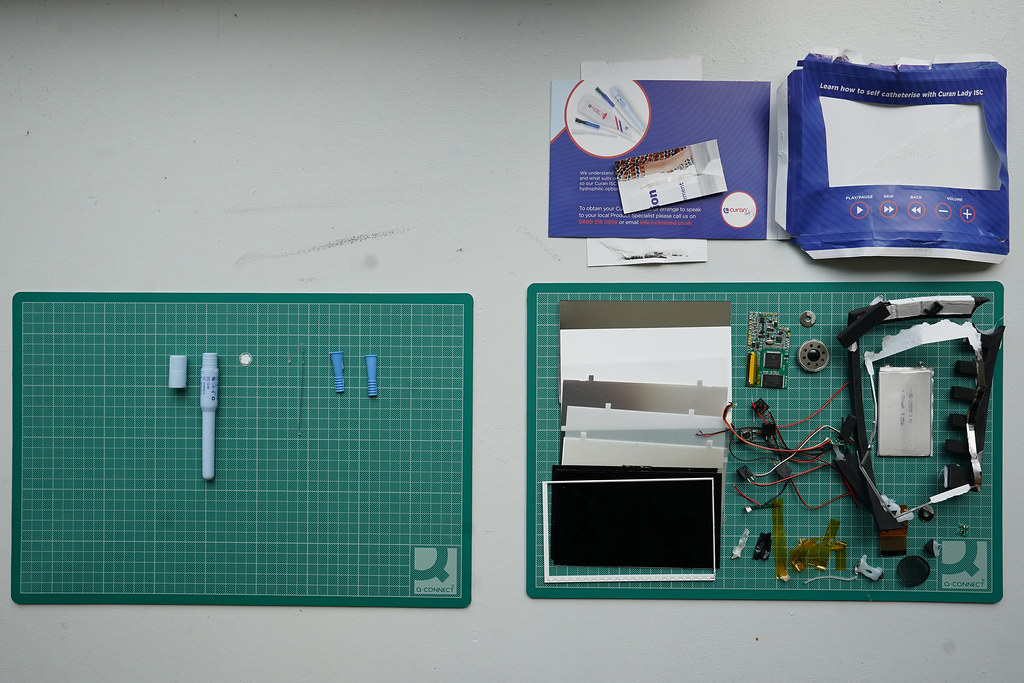 The many components that make up a self catheter kit, including an information video.