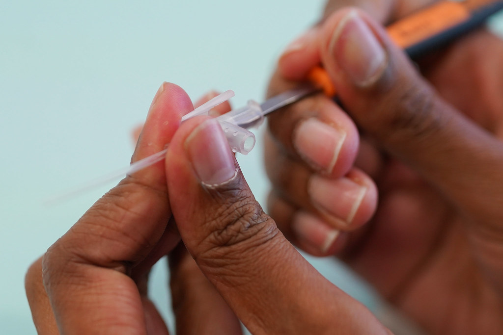 A researcher uses a scalpel to take apart their device.