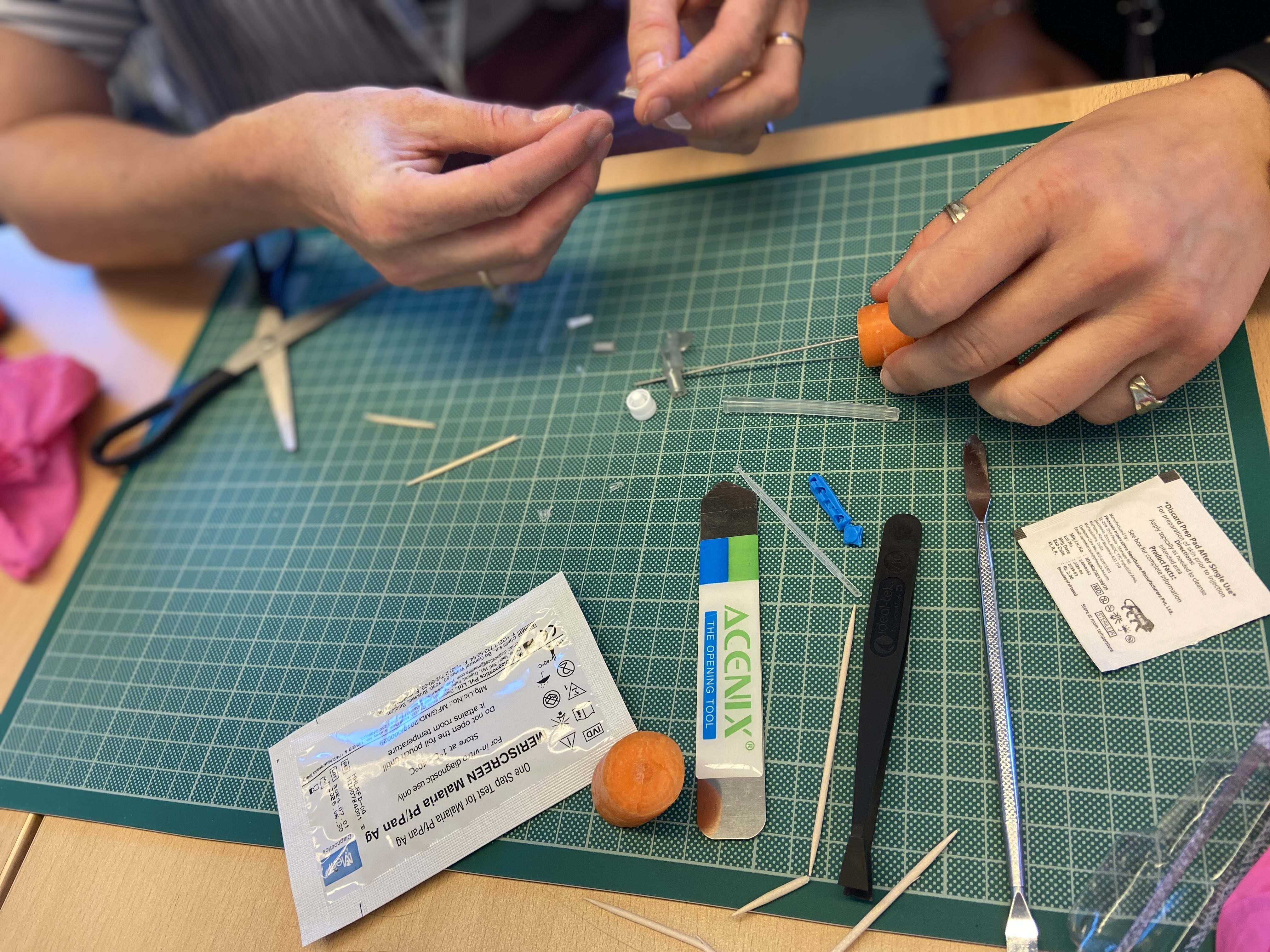 hands deconstruct a safety catheter