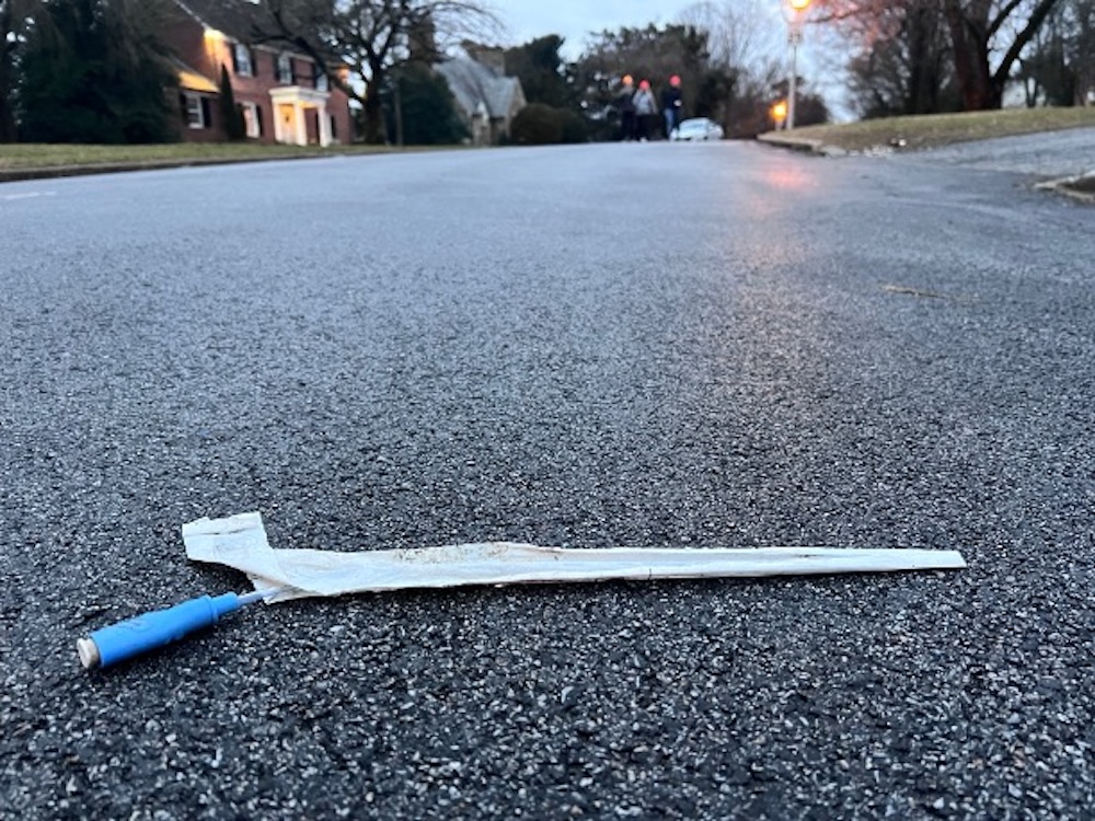 Medical waste lies discarded on a road.