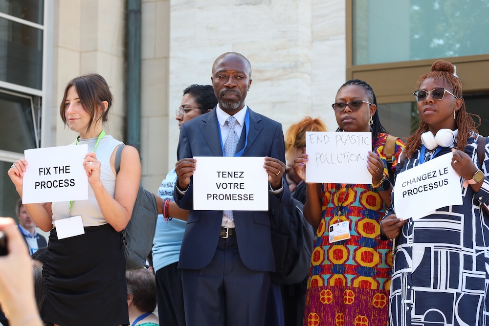 Members of the civil society coalition stage a silent protest outside the main plenary hall.