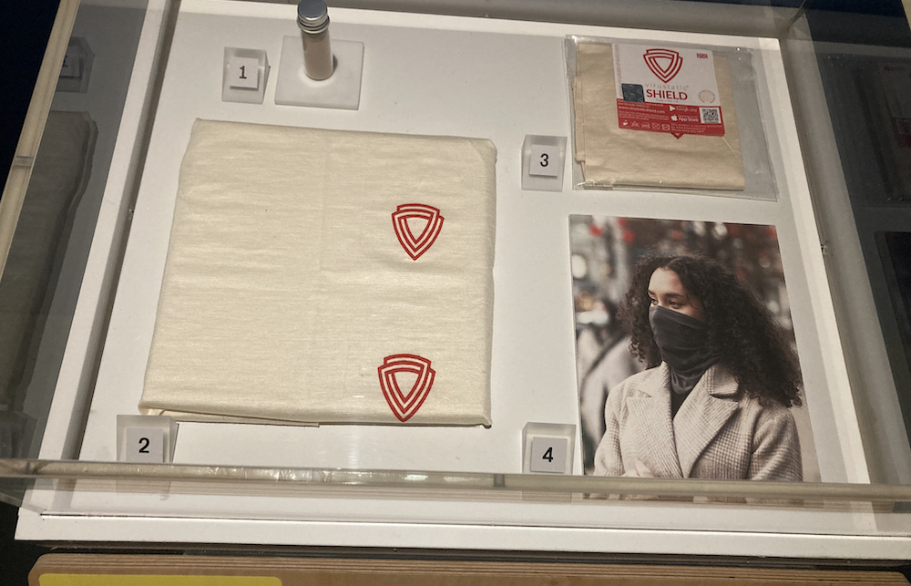 Display case with Virustatic reusable face mask.