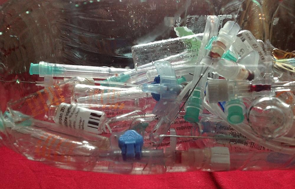 A close up of discarded syringes and medical waste