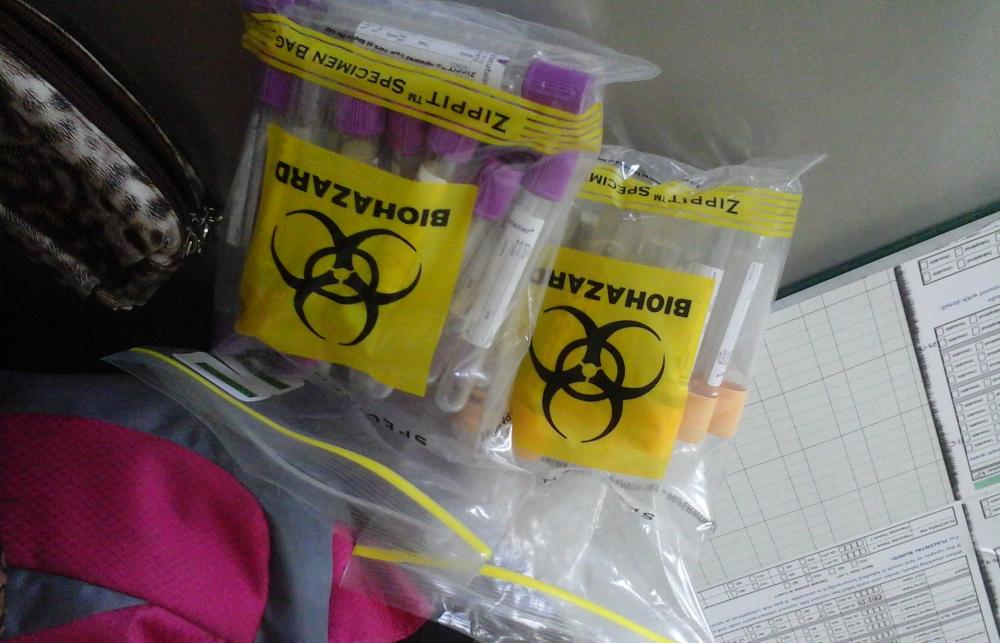 Two bags of biohazard waste on a table. 